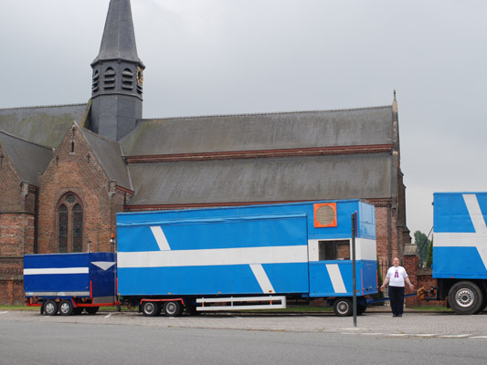 A man between trucks and church